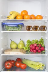 Open fridge full of fresh fruits and vegetables