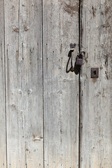 very old wooden door with padlock of greek house