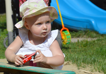 The child plays in the sandbox with the red children's typewriter "Fire guard 01"