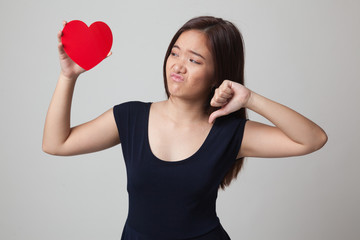 Fototapeta na wymiar Asian woman thumbs down with red heart.
