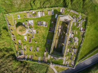 Aerial view of a beautiful old ruins of an Irish church and burial graveyard in county clare, Ireland. Set in the burren national park countryside landscape.