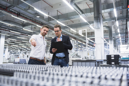 Two men talking in factory shop floor