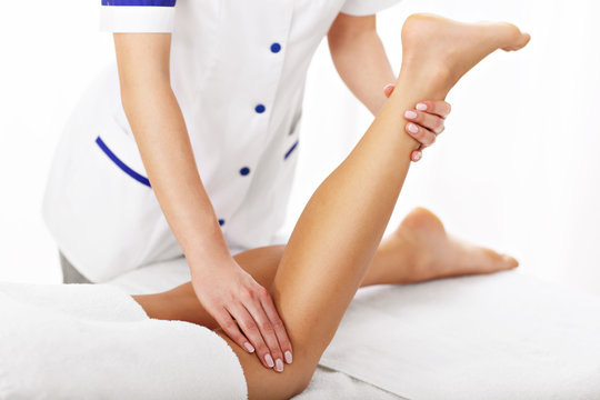 A picture of woman having leg therapy