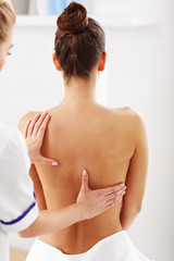 A picture of woman having back therapy