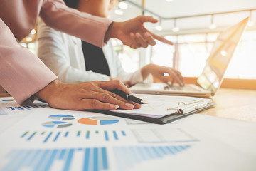 Business concept. Business people discussing the charts and graphs showing the results of their successful teamwork.