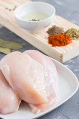 Chicken and ingredients for marinade. Preparing food. Chicken in marinade with herbs and spices. Ready for cooking.