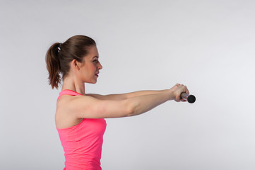 Fototapeta na wymiar Young fit woman exercising with bodybar