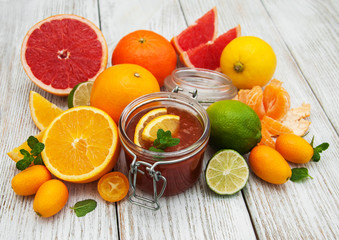 Jar of jam and fresh citrus fruits