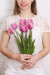 purple tulips in woman hands