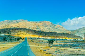 Naklejka na ściany i meble view of a road leading to the Jebel Shams in Hajar mountains in Oman.