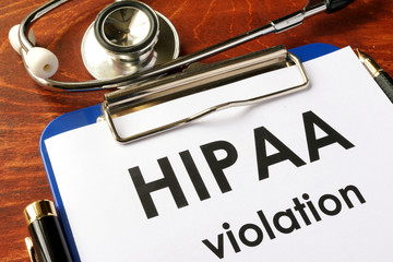 HIPAA violation form on a clipboard. Medical confidentiality concept. - obrazy, fototapety, plakaty