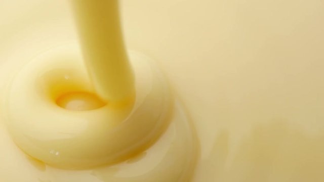 Pouring sweetened condensed milk. Close-up shot.