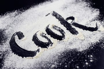The inscription on the flour. Cook. Black background