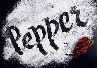 The inscription on the flour. Pepper. Black background