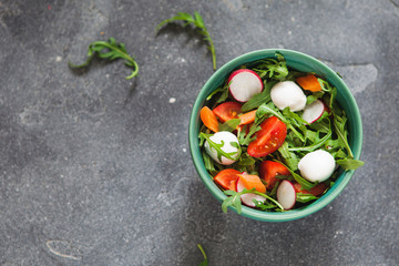 Fototapeta na wymiar Fresh salad with mozarella, arugula and tomato
