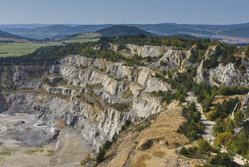 Fototapeta na wymiar Limestone mine in Koneprusy, Czech Republic. Deep opencast mines leave great environmental impact.