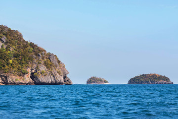 Fototapeta na wymiar view of small island limestone rock in andaman sea under blue sky background at krabi Thailand