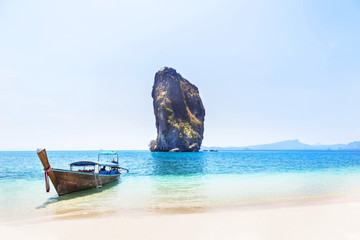 longtail boat with small island in andaman sea under blue sky at krabi Thailand