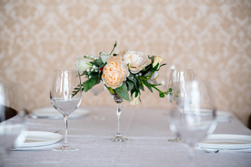 Dining table setting decorated with flowers.