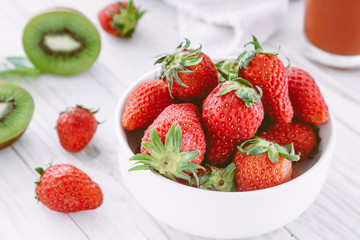 Fresh Strawberry in a bow on wooden table