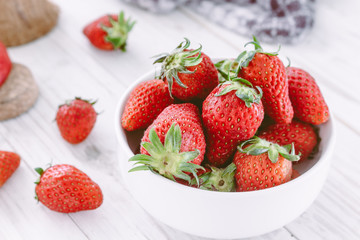 Fresh Strawberry in a bow on wooden table