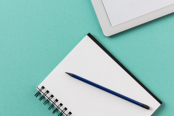 top view of notebook with pencil and digital tablet mock-up, small office home office