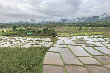 Aerial View of Village landscape and River over Clouds in Chiangdao Thailand
