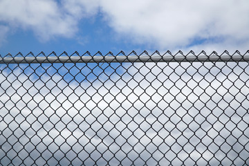 iron chain link fence against sky