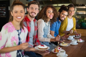Portrait of friends sitting at restaurant
