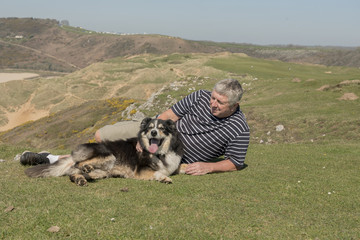 Naklejka na ściany i meble Happy mature man outdoors with sheep dog
