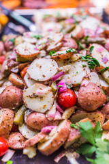 Closeup of roasted potatoes with herbs and vegetables