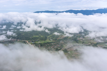 Aerial View of Village landscape and River over Clouds in Chiangdao Thailand
