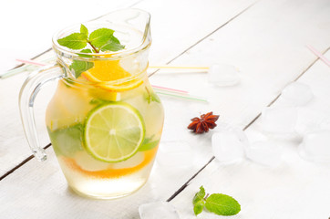 Jug with Lime and Orange Fruit Water with ice