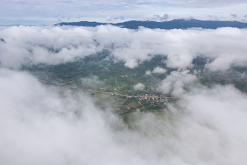 Aerial View of Village landscape and River over Clouds in Chiangdao Thailand
