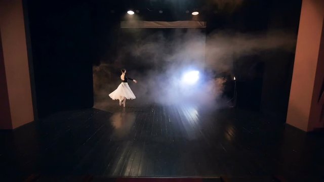 Ballerina moving around the stage in slowmotion. Steadicam. HD.