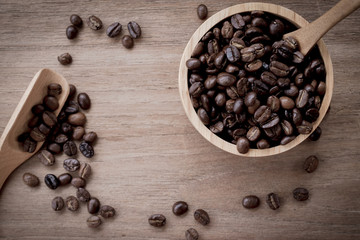 coffee beans isolated on wood background.