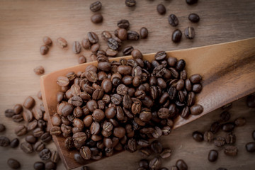 coffee beans isolated on wood background.