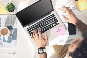 overhead view of casual businessman working on laptop at modern office, business men computer