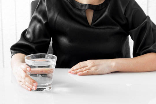Female hand holding a glass of water
