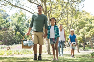 Fototapeta premium Family arriving in the park for picnic