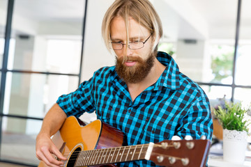 Man playing guitar in office