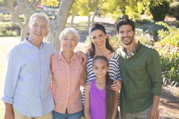 Happy family standing together in the park