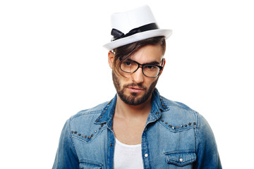 Bearded man with a hat posing in the studio