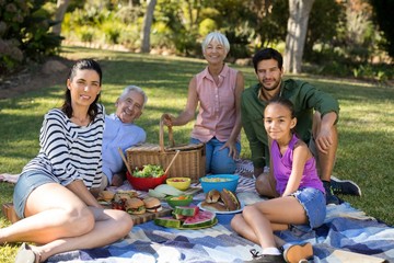 Portrait of happy family having picnic in the park