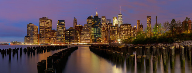 Fototapeta na wymiar New York City Manhattan skyline with skyscrapers over Hudson River illuminated lights at dusk after sunset.