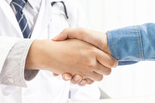 Doctors office and businessman shaking hands