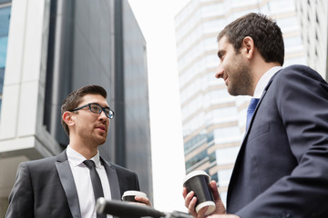 Two businessmen talking outdoors