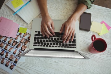 Hands of female photo editor using laptop in office