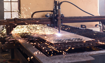 Working water jet machine cutting metal shapes in the steel & pivot manufacturing industry.