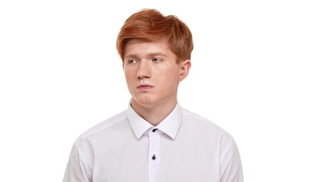 Dissapointed foxy handsome Caucasian young man heavily sighing from headache. Footage on white background in slowmotion